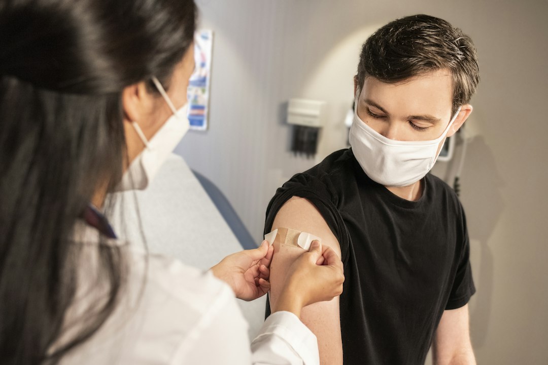 Healthcare worker applying a bandage after vaccination