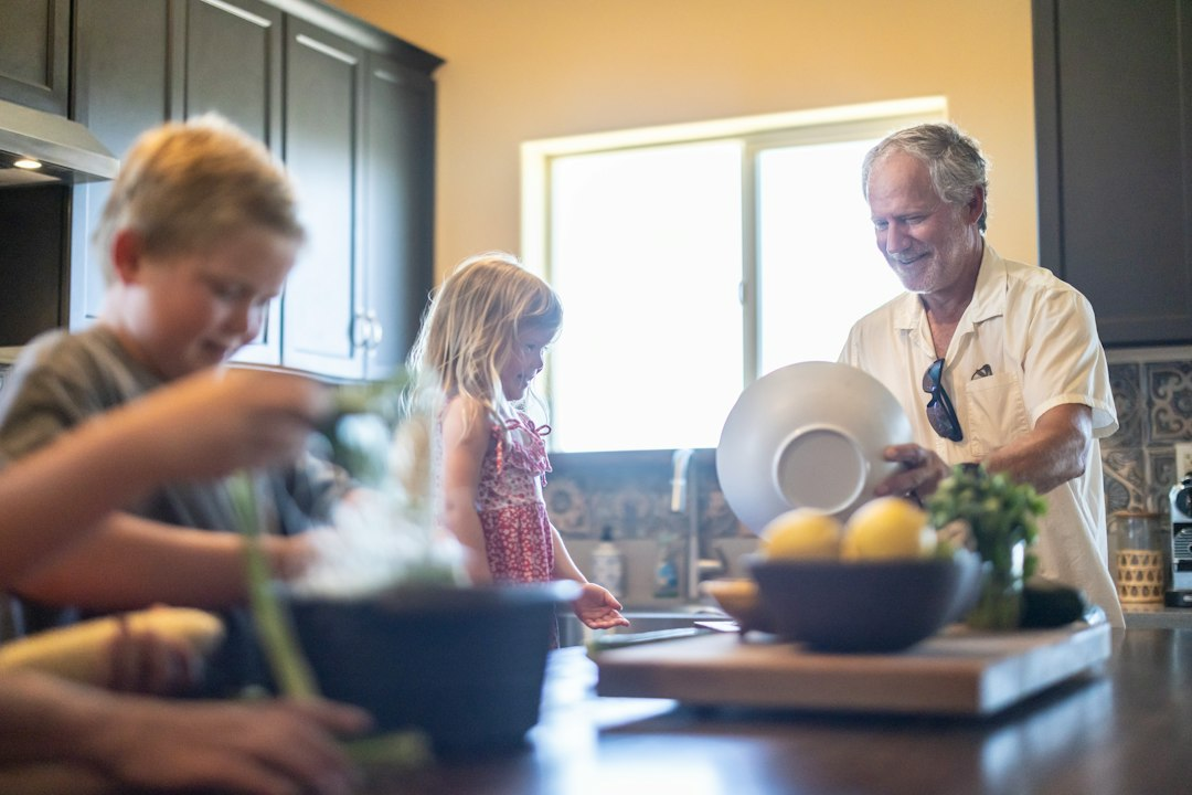 Family members preparing food together in a kitchen