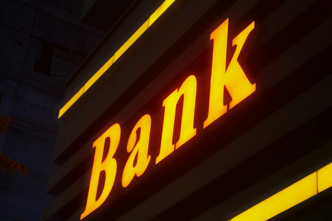 Illuminated bank sign at night; illustrative image, not Nano Banc or Sunwest Bank
