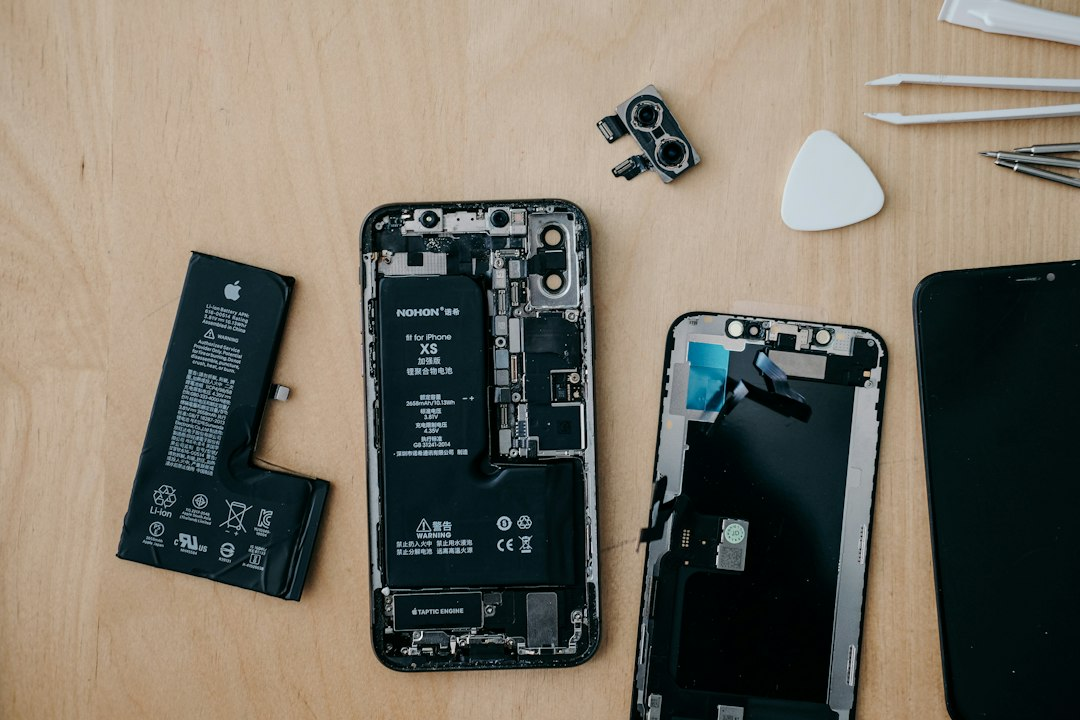 A technician repairing a smartphone