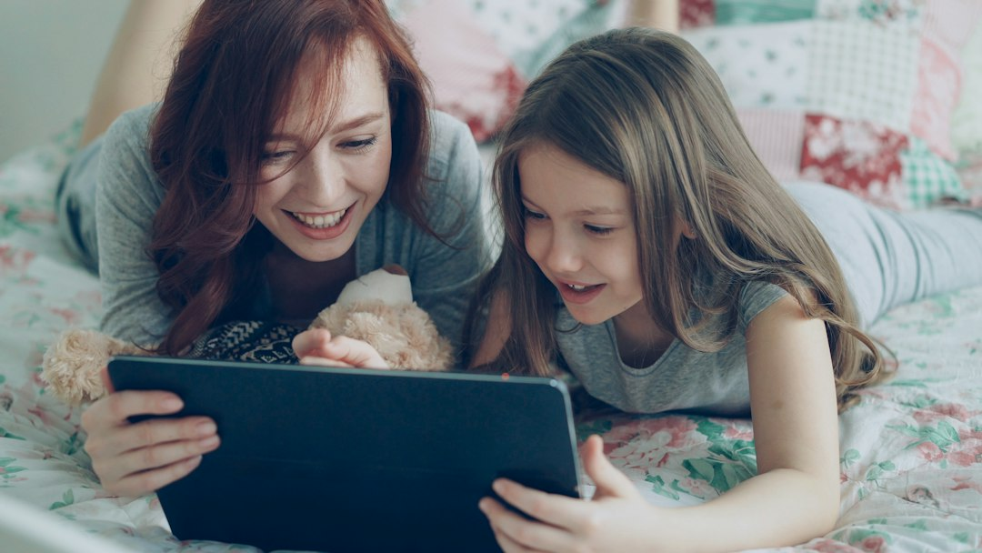 A parent and child using a tablet together