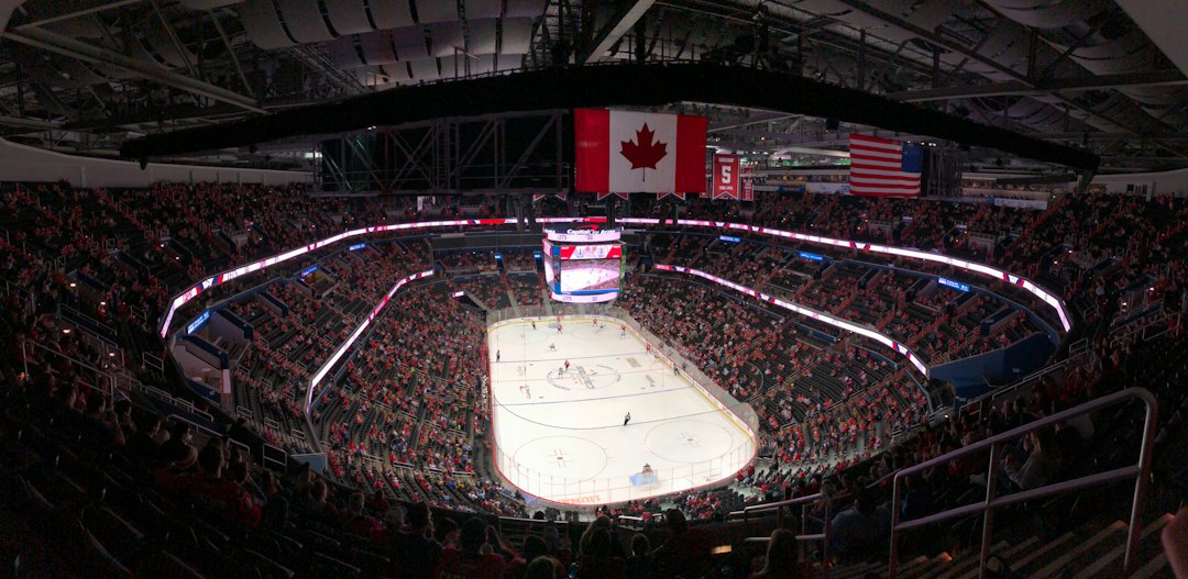 Ice hockey arena with Canadian and American flags, illustrative image