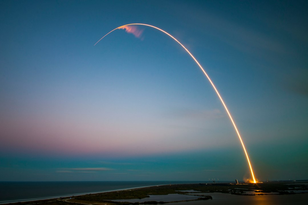 Rocket launch light trail at dusk; illustrative image, not Crew-13
