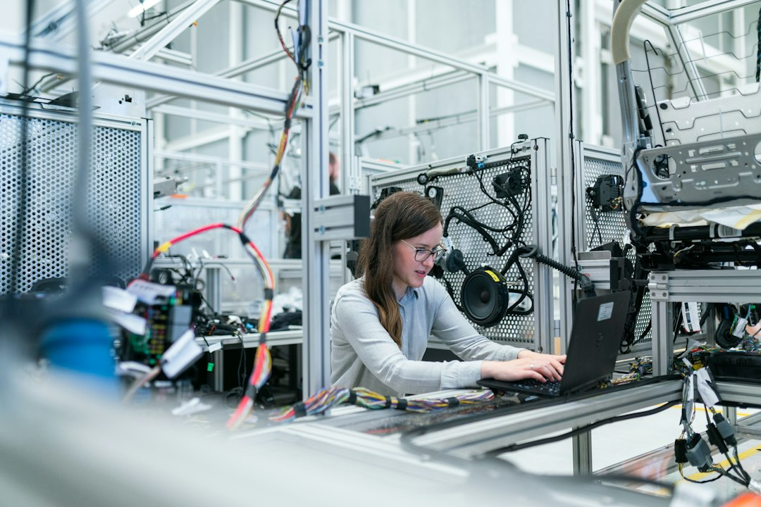 Engineer reviewing equipment at an industrial manufacturing workstation