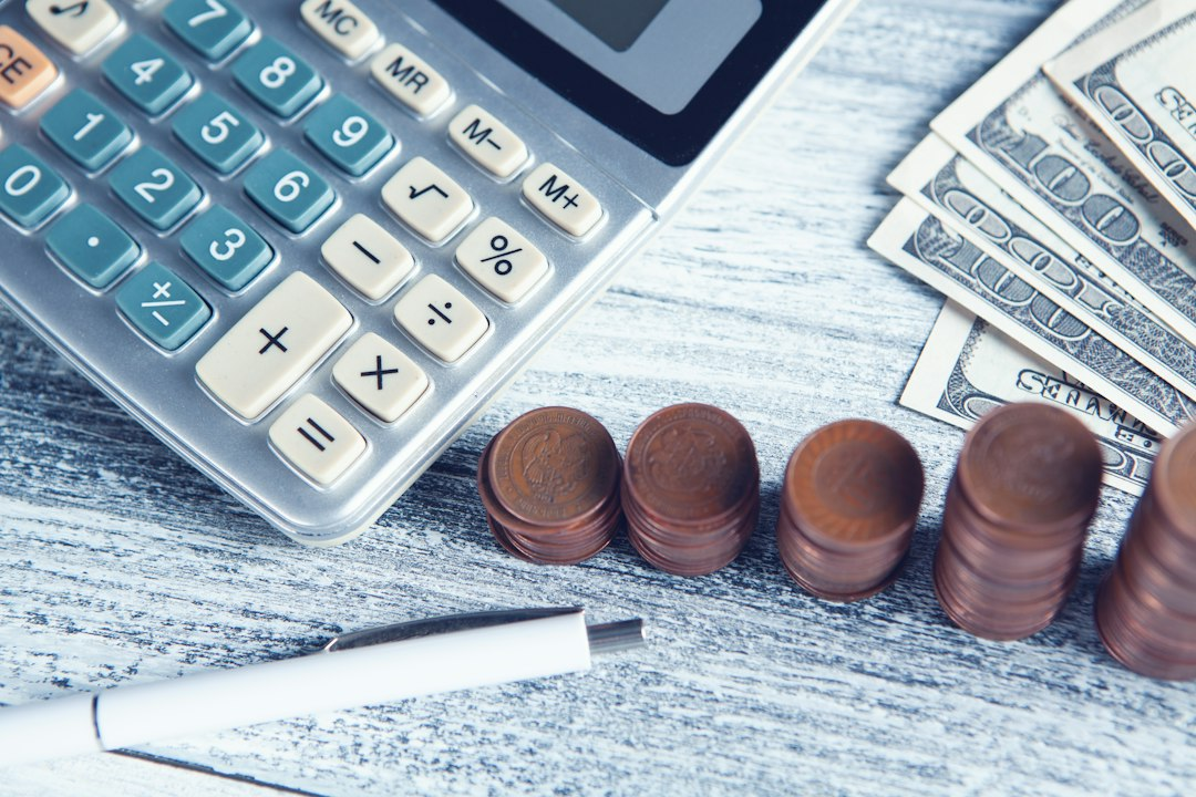 Calculator, pen and U.S. currency on a table