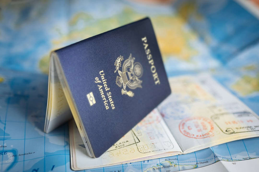 United States passport open on a colorful world map