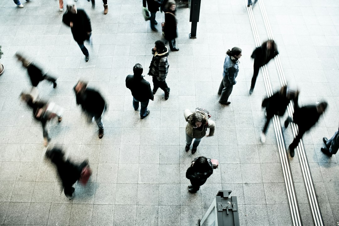 People walking through a railway station; illustrative image for employment data