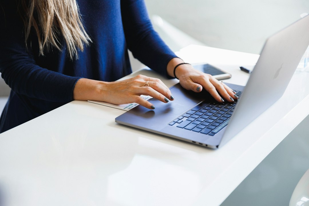 Person researching information on a laptop at a desk
