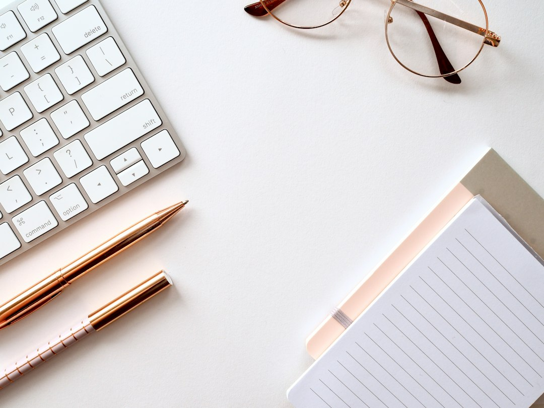 Notebook, pen, and glasses on a planning desk