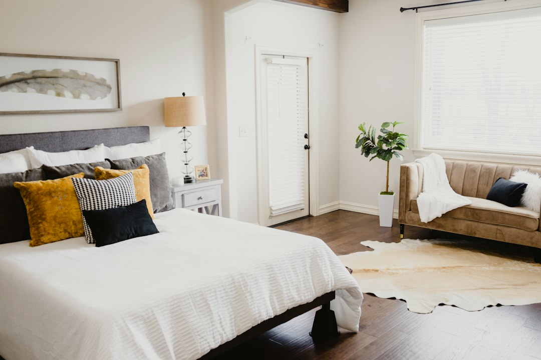 White bed and linen in a bright bedroom, illustrative photograph