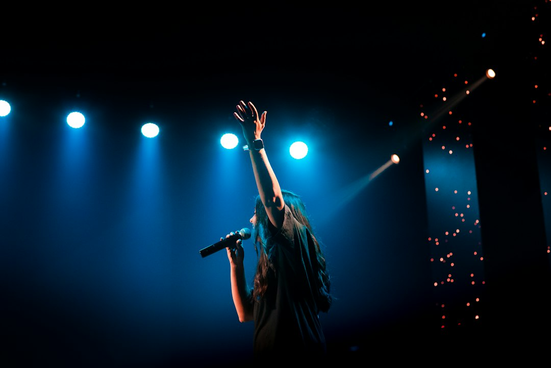 Musician performing under stage lights at a concert