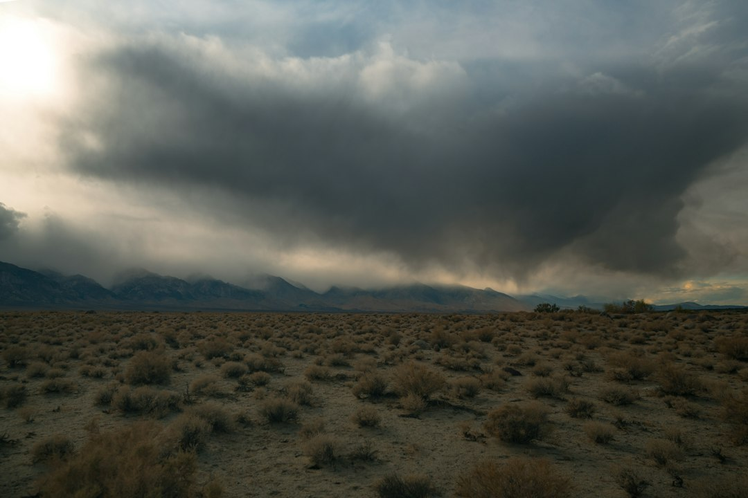 Dark rain clouds over a mountain landscape