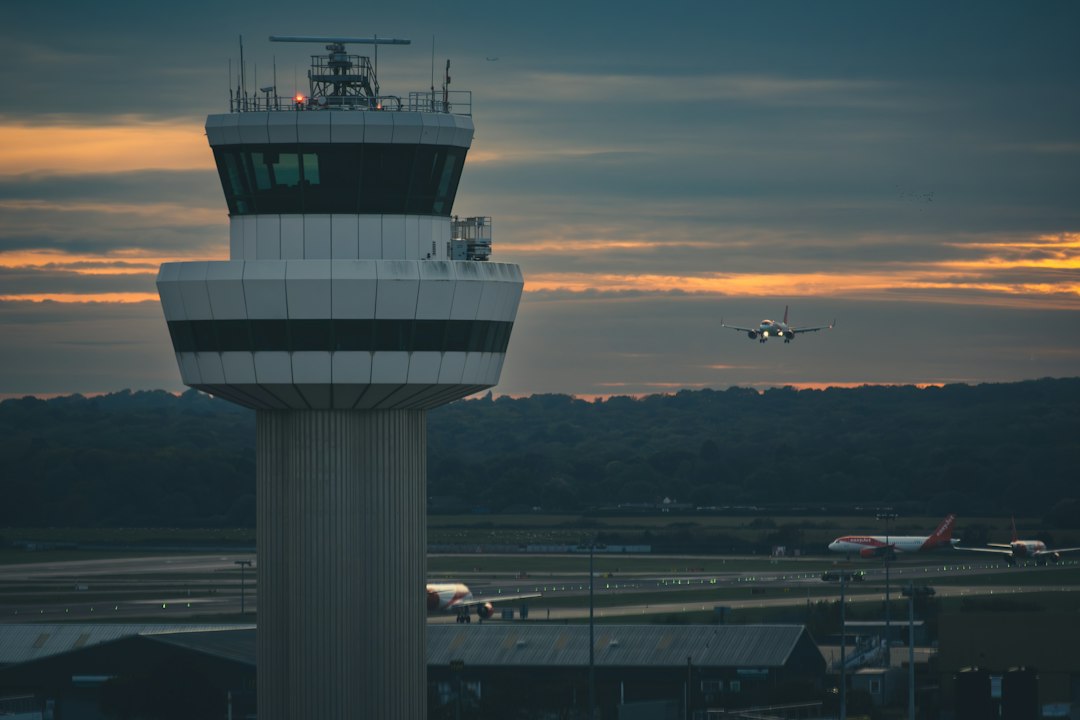 Air traffic control tower overlooking an airport runway at dusk
