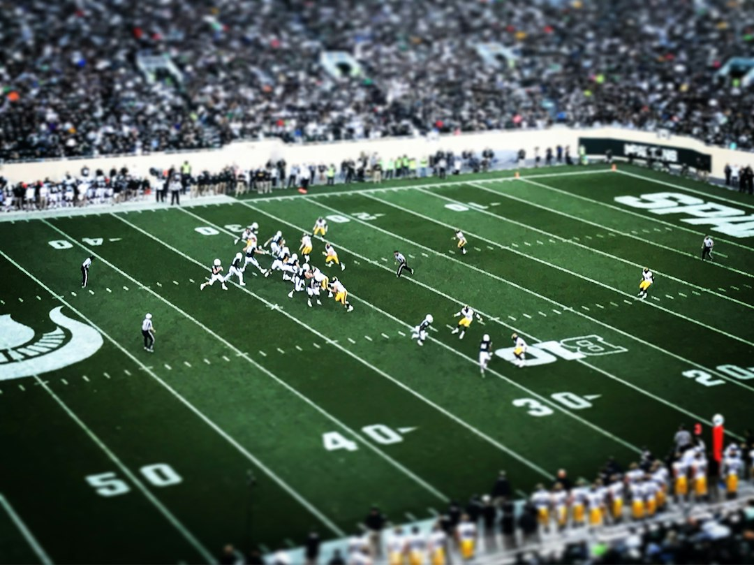 American football players competing under stadium lights