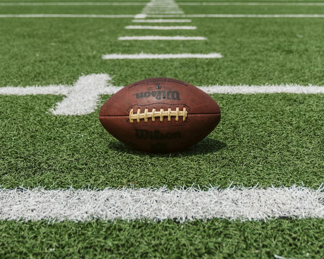 American football resting on a field