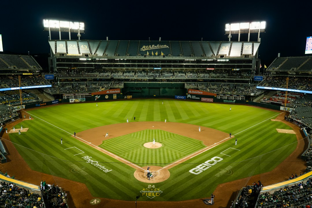 A baseball stadium filled with spectators under bright lights