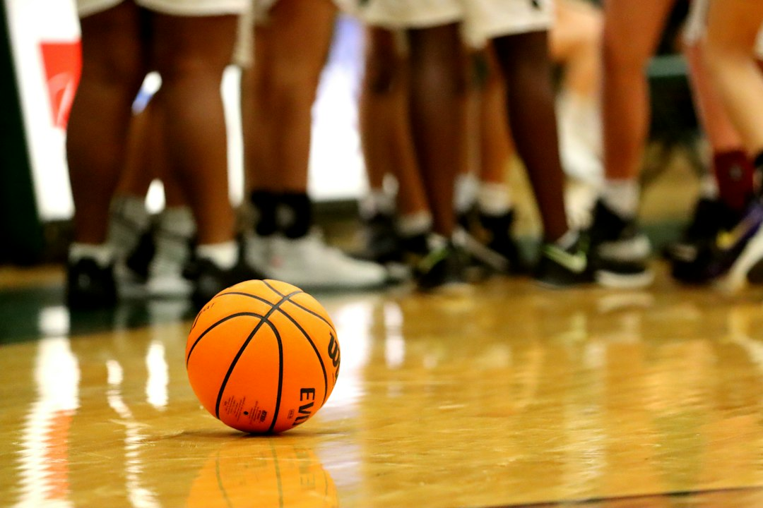 Basketball resting on an indoor hardwood court