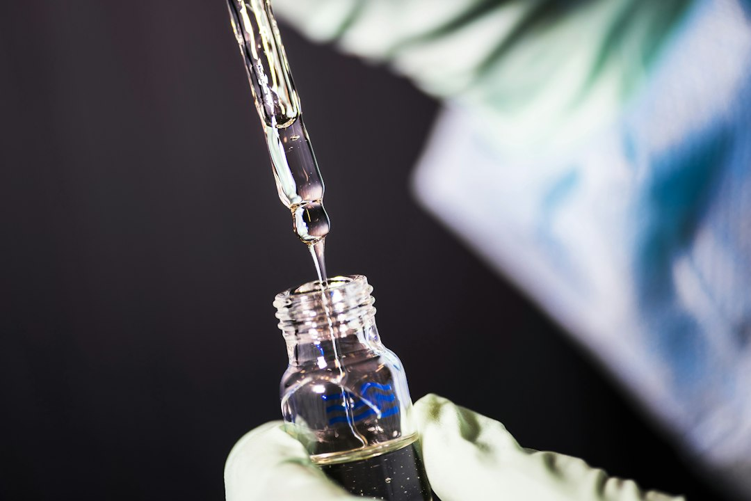Laboratory technician pipetting a sample in a CDC lab