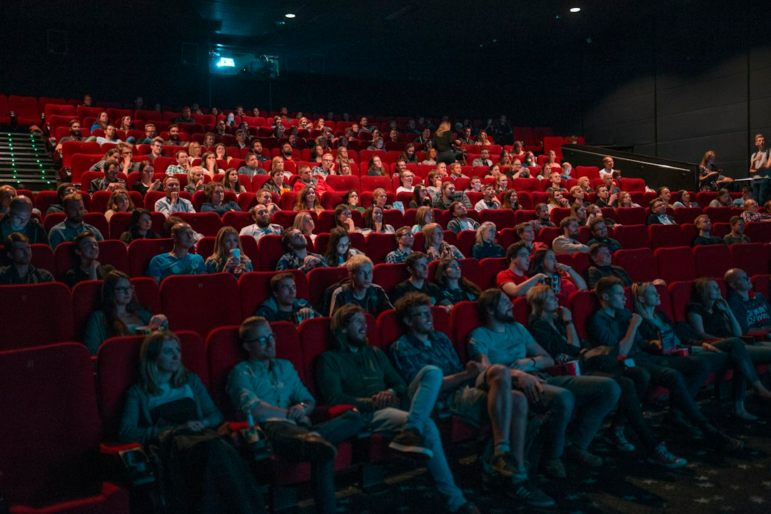 Audience watching a screen in a theater; illustrative image