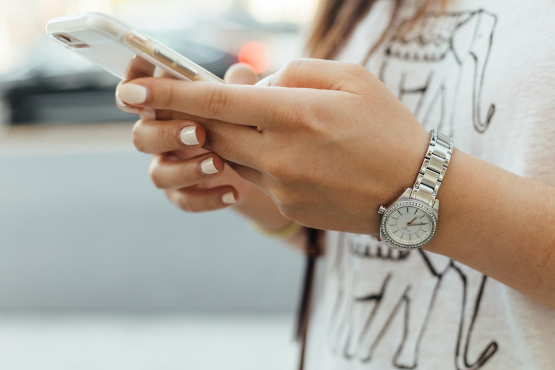 A person using a smartphone, illustrating a mobile cash-advance refund