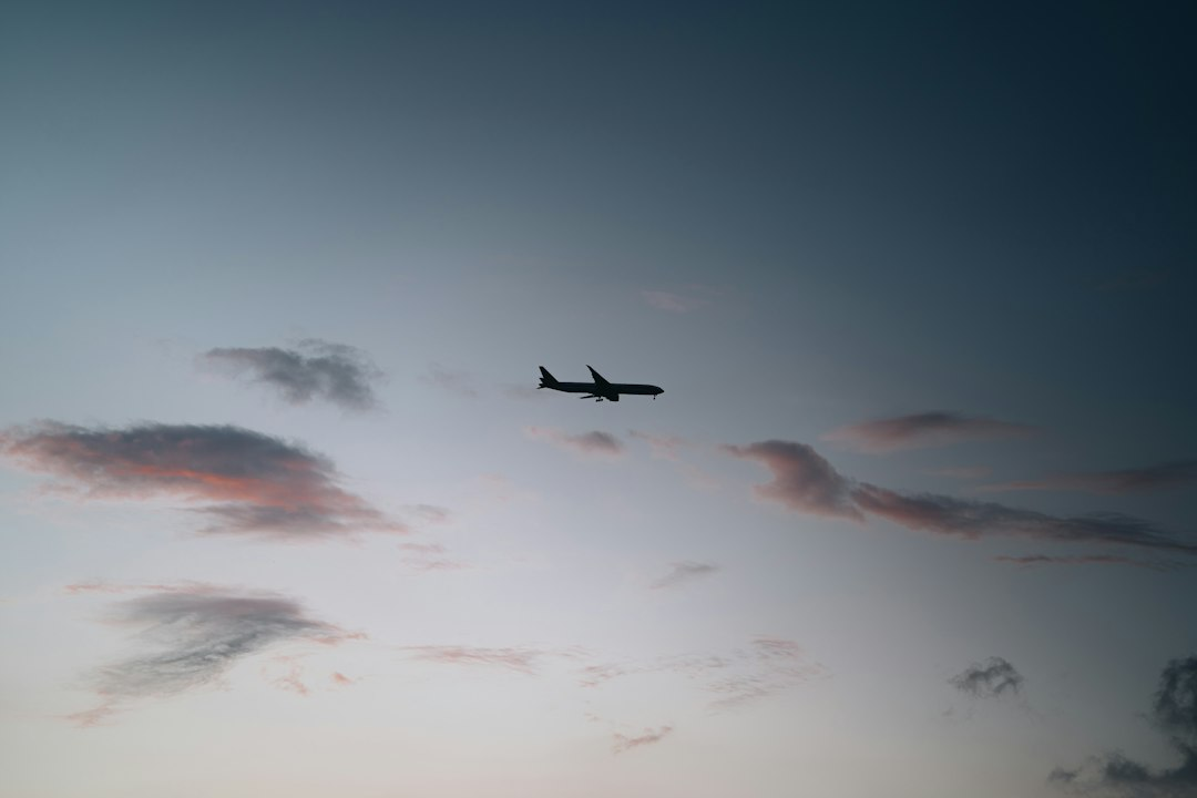 Commercial passenger airplane flying above clouds at dusk, illustrating the FlyDubai FZ1073 report
