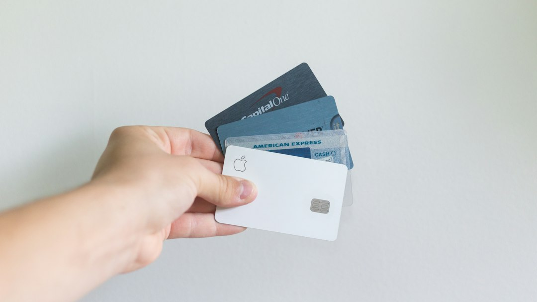 Person holding several credit cards