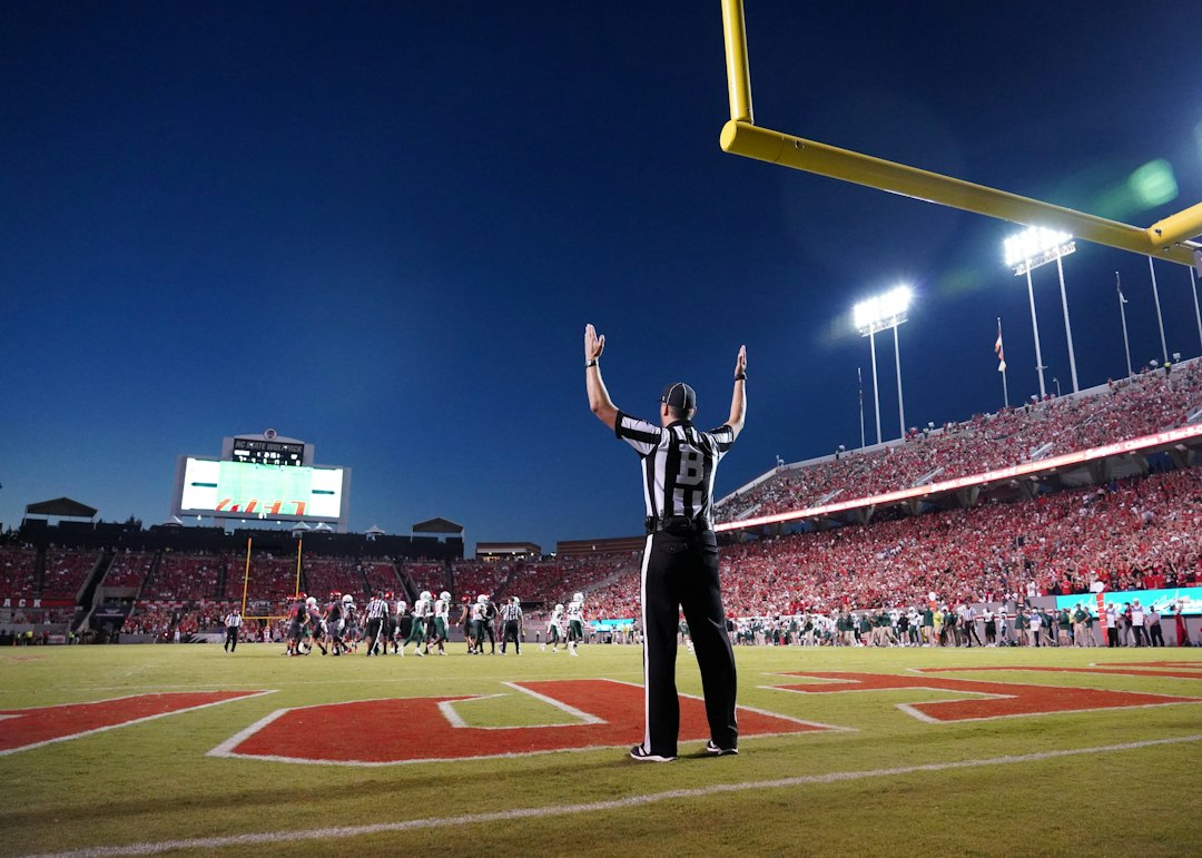 American football player celebrating on a field, illustrating the Cowboys-Texans Week 4 game