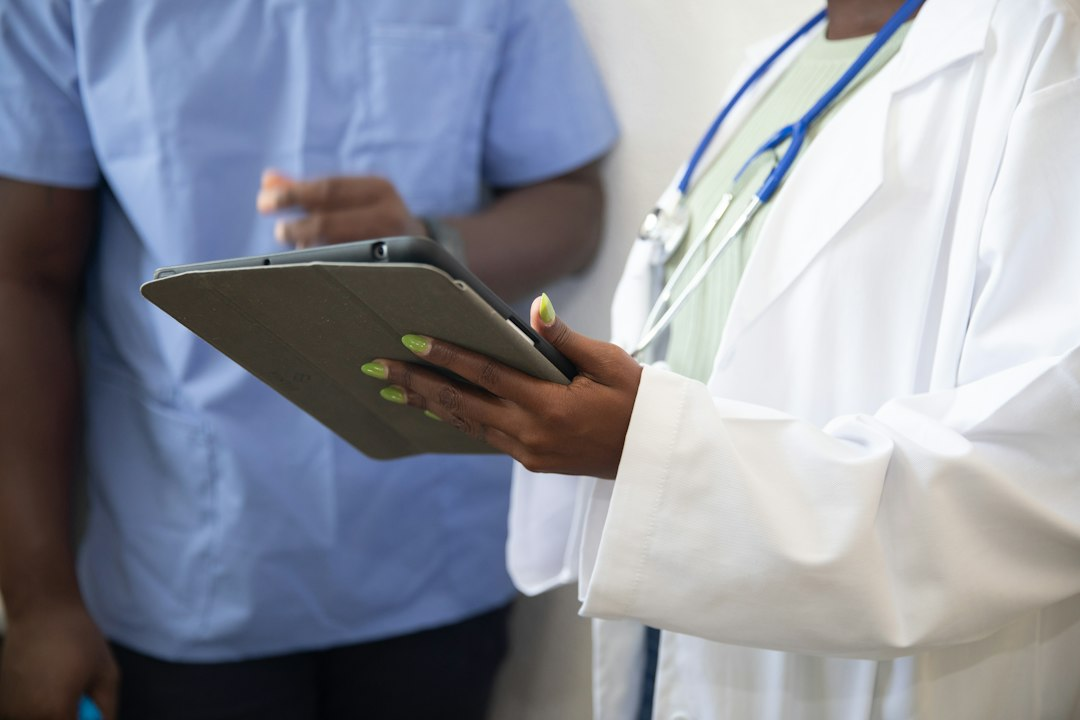 Doctor showing healthcare information to a patient on a tablet