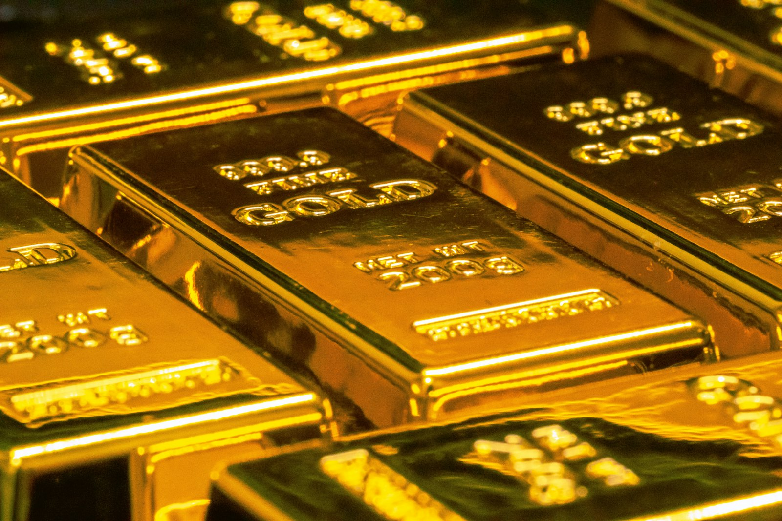 Stacked gold bars illustrating assets described in a federal fraud case