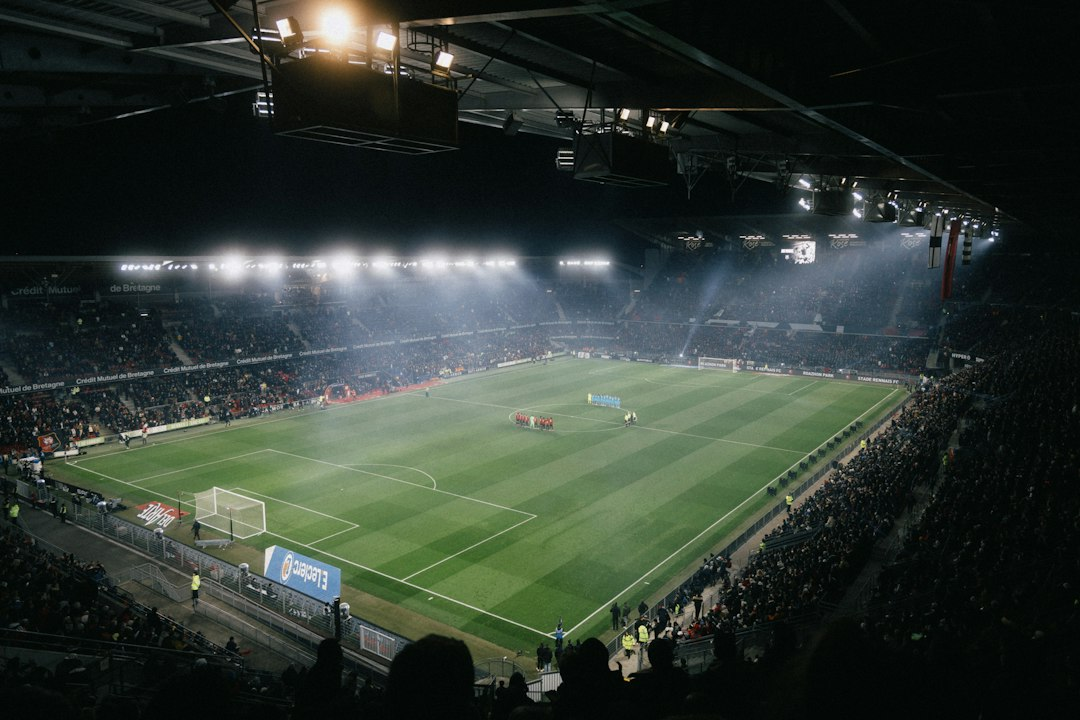 Illuminated football stadium and field at night