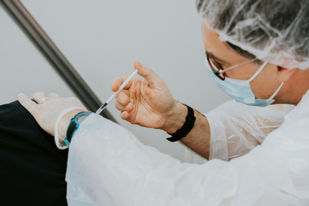 A clinician writing notes, illustrating vaccine-event research and reporting