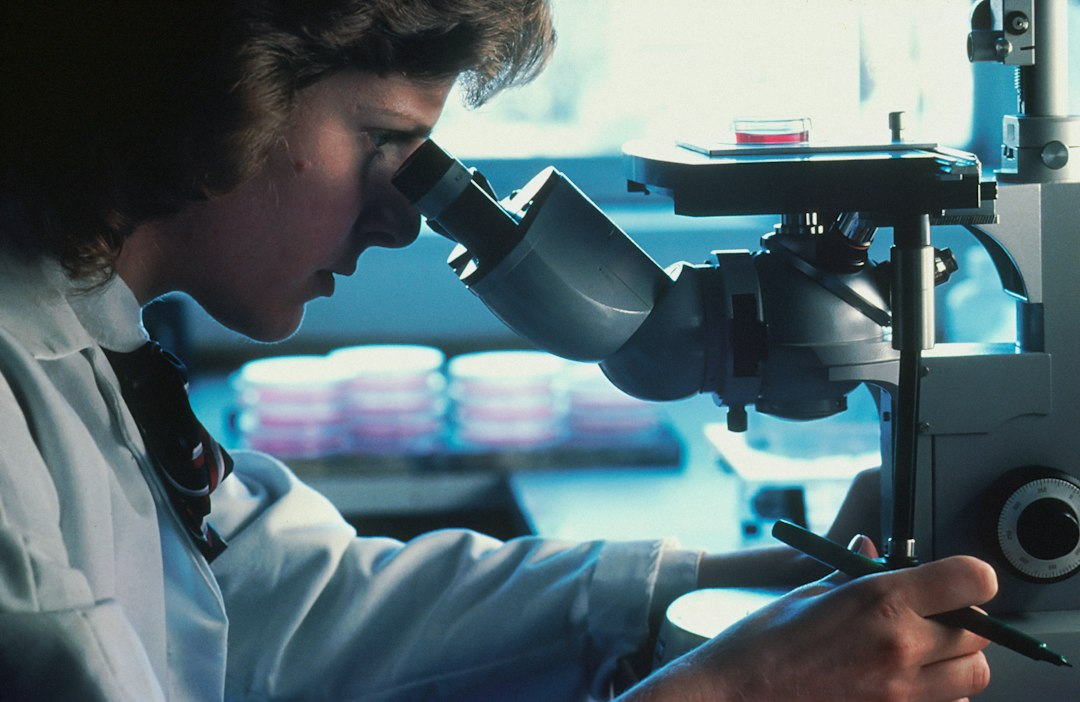 Scientist using a microscope illustrating the Irkutsk health investigation