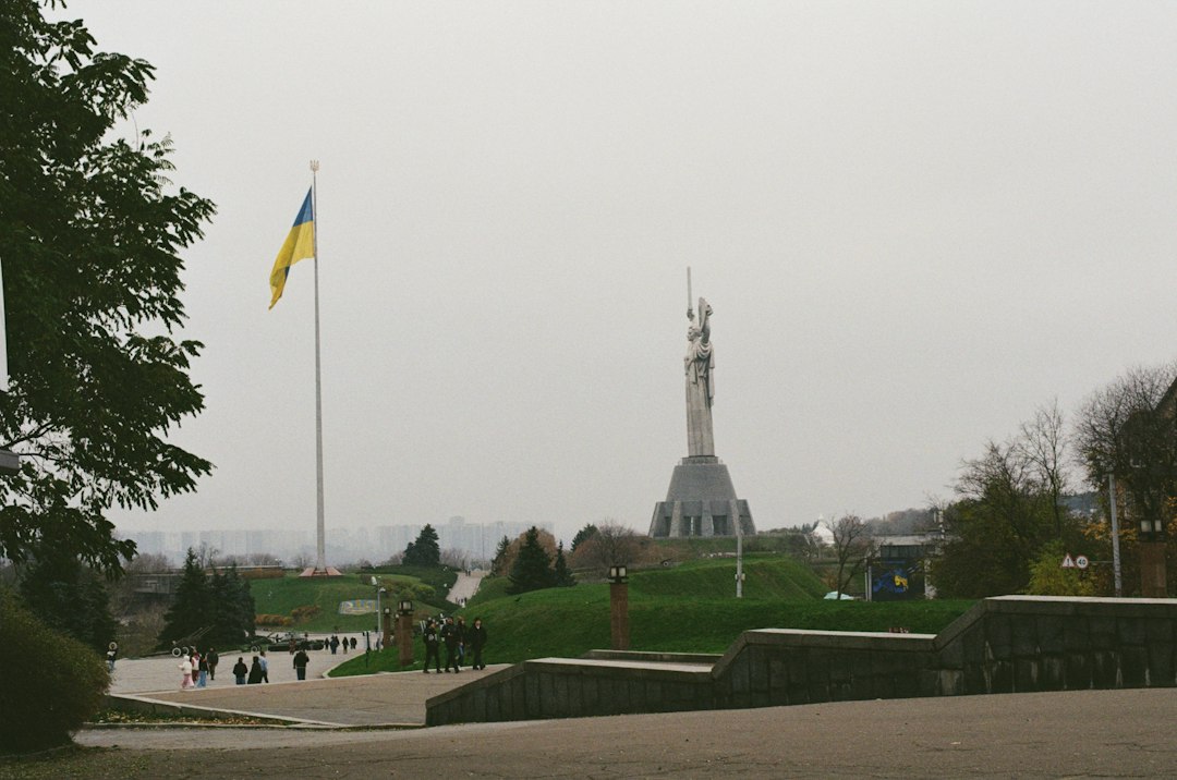 Ukrainian flag flying over a monument in Kyiv