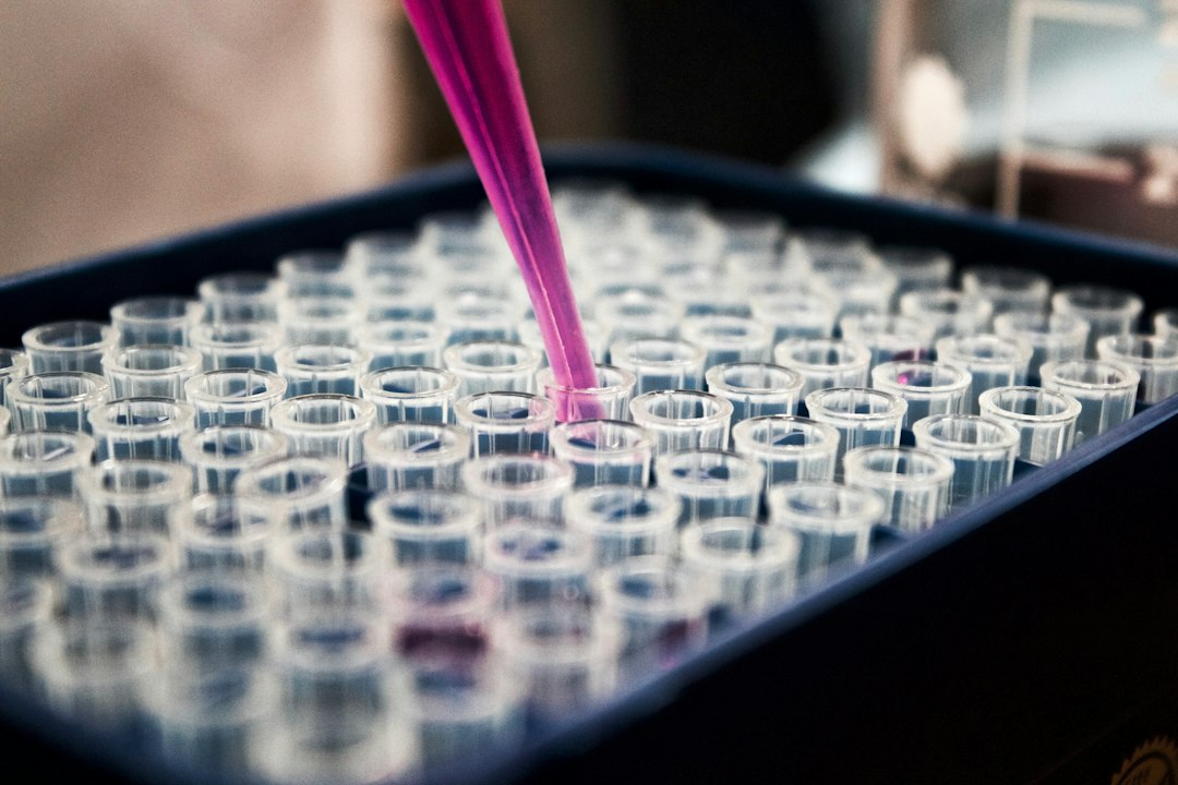 Scientist using a pipette in a medical research laboratory