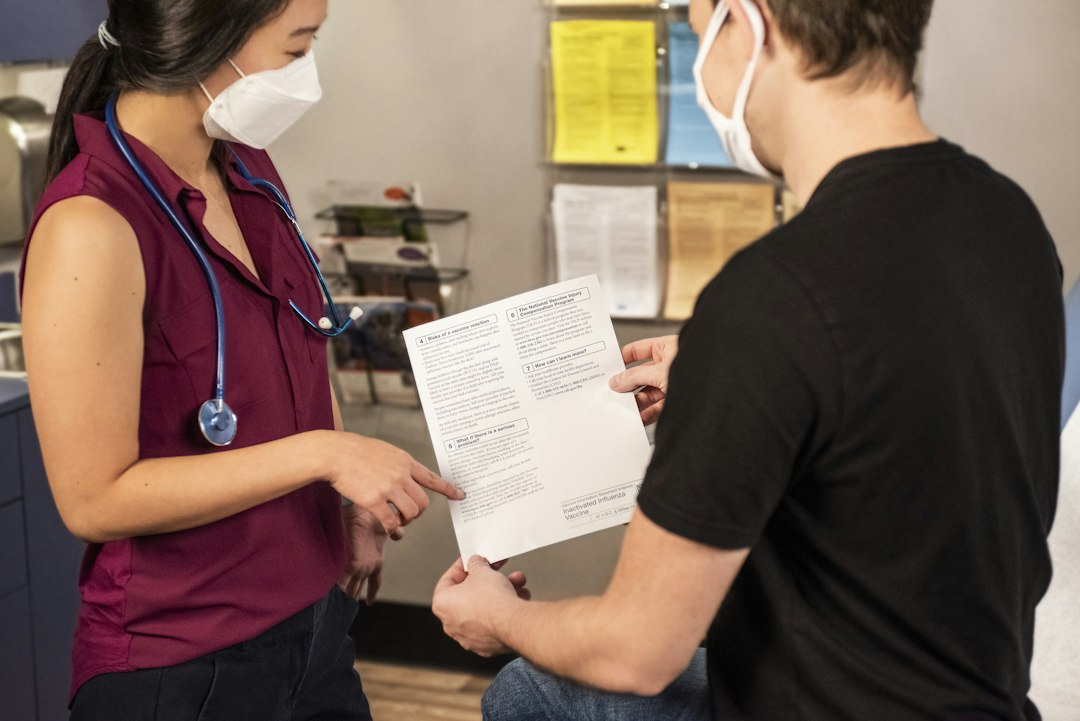 Health care provider speaking with an older patient in a clinical setting, illustrative of Medicare coverage