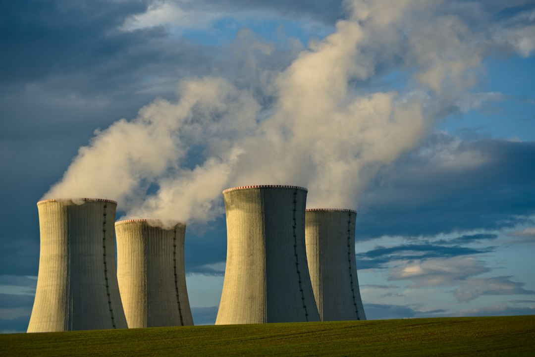 Cooling towers at a nuclear power plant under a blue sky