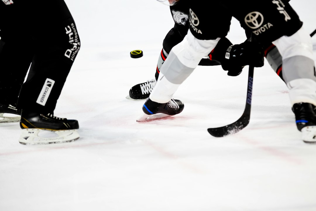Ice hockey players competing on an indoor rink