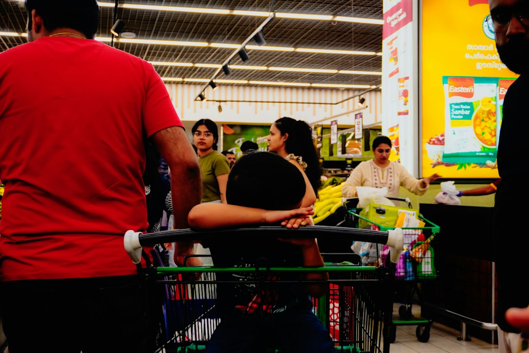 People shopping in a brightly lit supermarket aisle