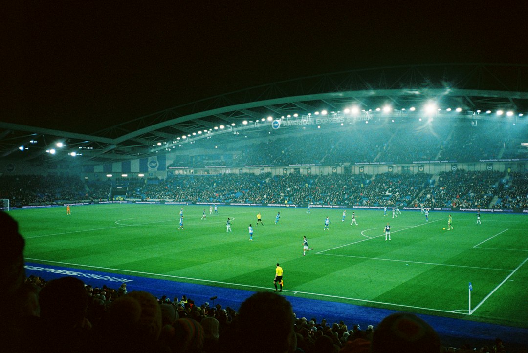 Soccer match under stadium lights at night