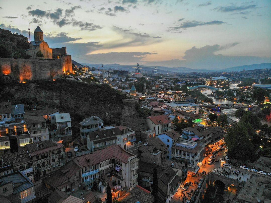 Aerial view of Tbilisi, Georgia, with dense city buildings and hills