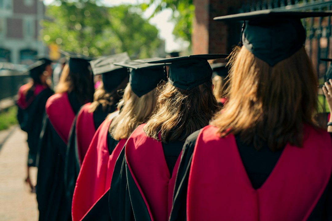 University graduates seated outdoors during a commencement ceremony