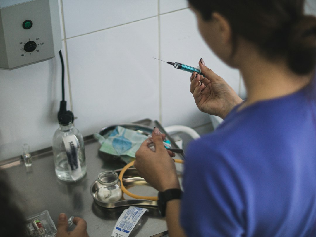 Health care worker preparing a syringe in a clinical setting
